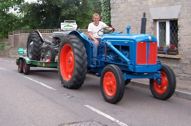 Tractor pulling trailer with second tractor